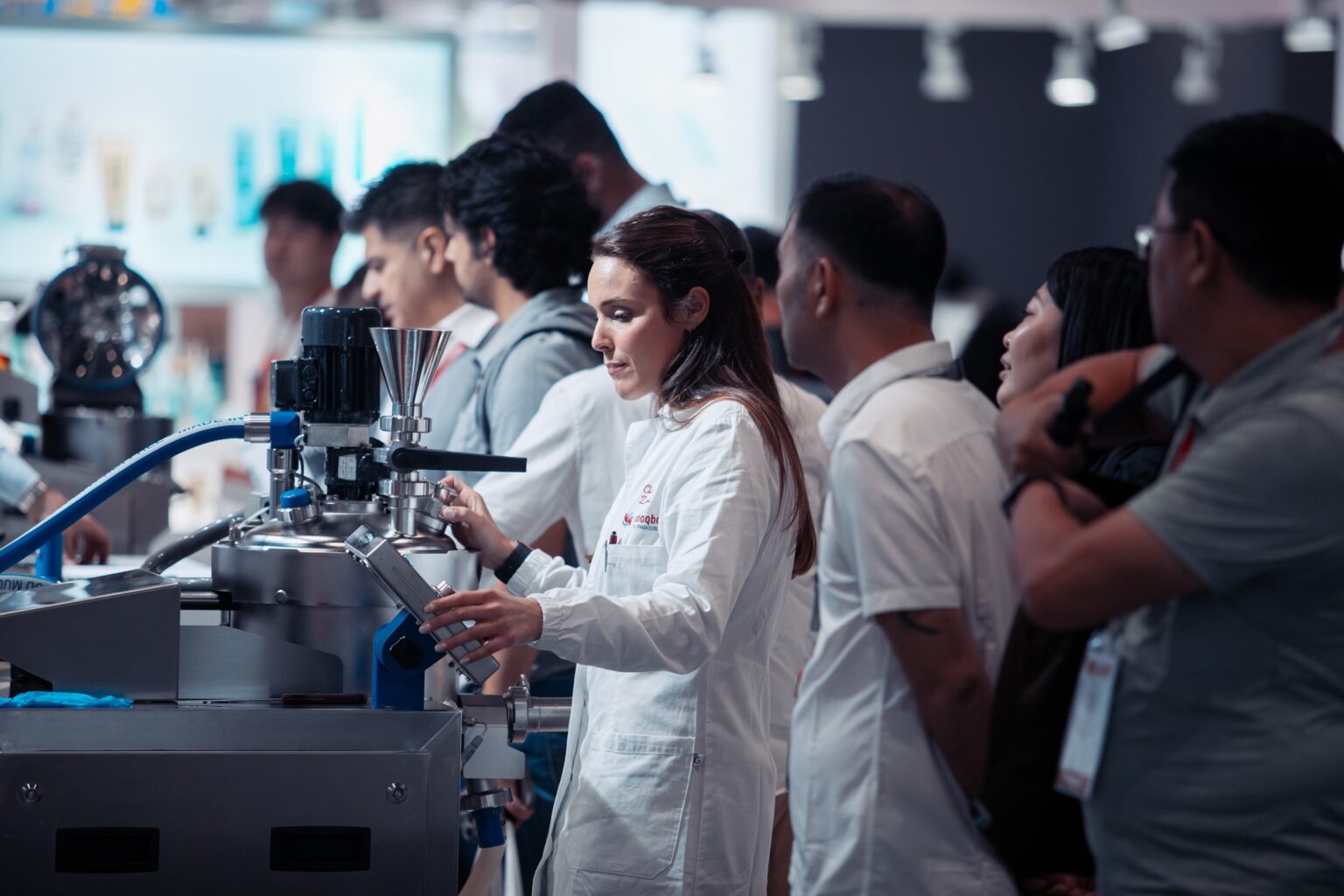 A live processing-machinery demonstration on the Cosmopack floor.