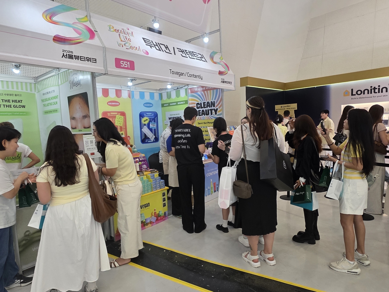 Visitors queue at K-beauty exhibitor booths at Seoul Beauty Week 2026, DDP Seoul